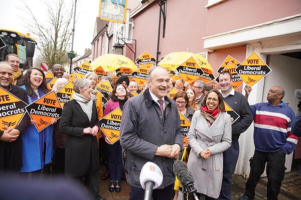 Ed Davey in front of crowd with Lib Dem diamond signs