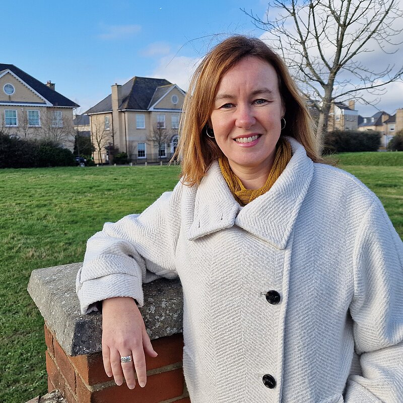 Marie Goldman standing in front of some houses