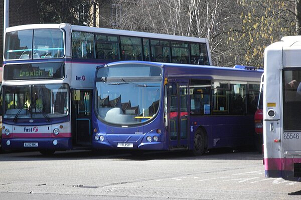 A double decker and blue single deck bus parked side by side