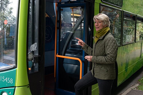 Pippa Heylings stepping on to a bus